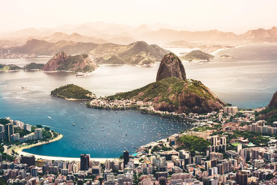 Sugarloaf Mountain and Botafogo Bay in Rio de Janeiro, seen from above at sunset.